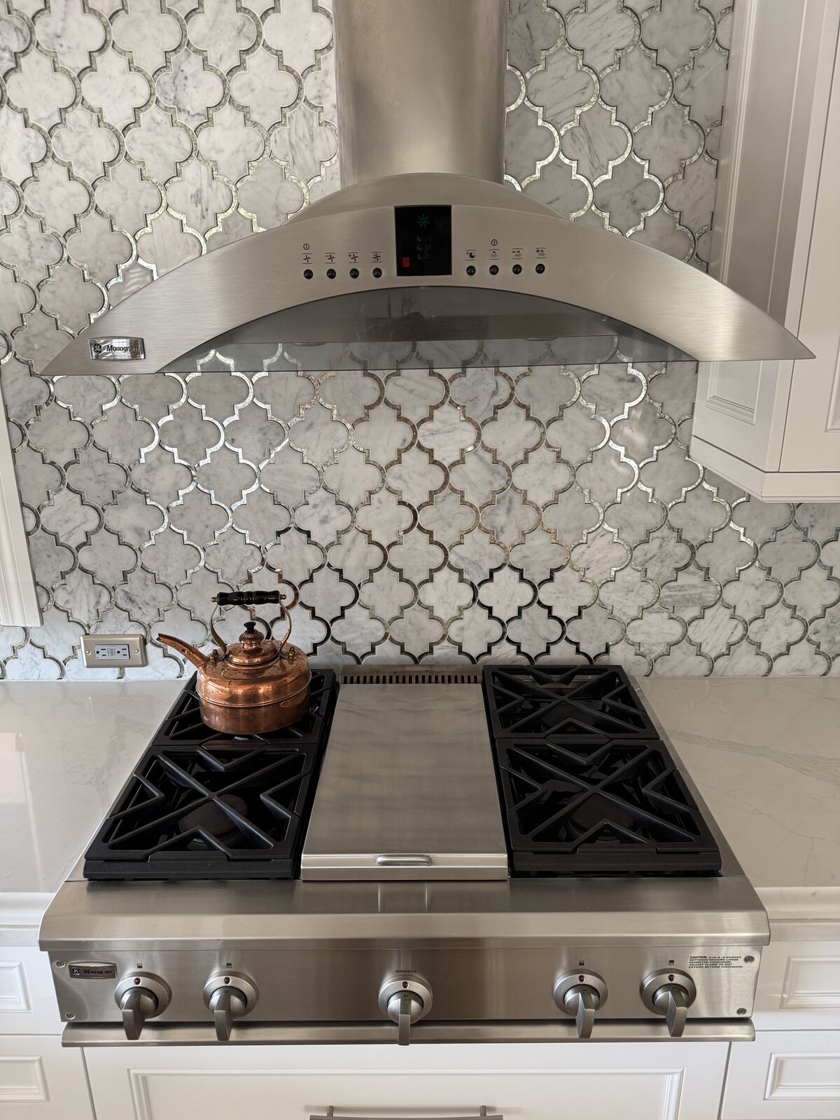 GE Monogram rangetop and hood in a luxury Lexington kitchen